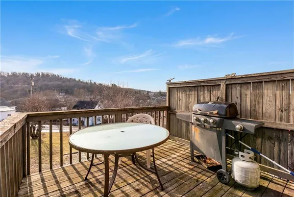 a balcony with table and chairs