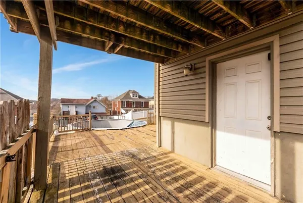 a view of a house with wooden fence