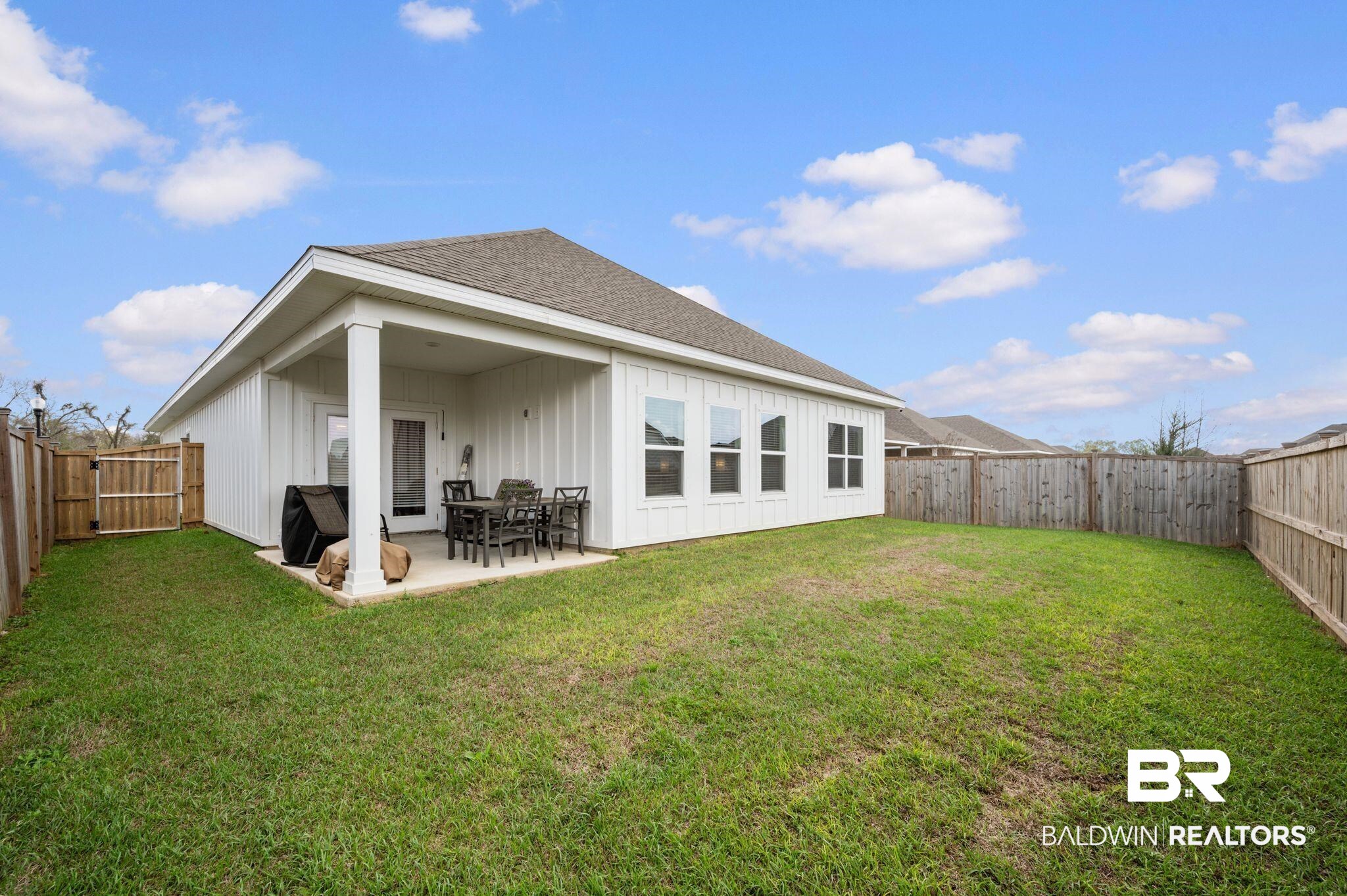 8508 Rosedown Lane Daphne, AL 36526 - Photo 24 of 29 Back of property featuring a fenced backyard, board and batten siding, roof with shingles, and a patio