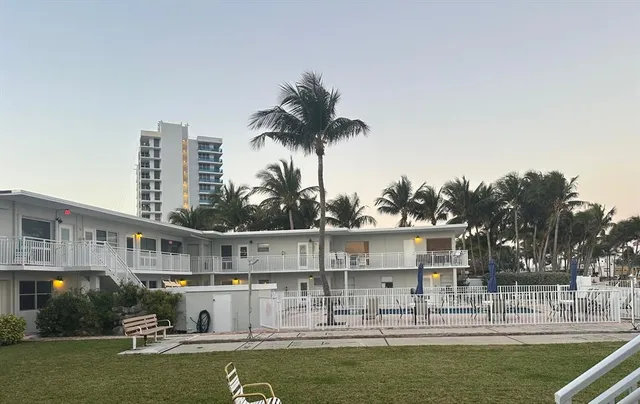 a view of a swimming pool with a garden and plants