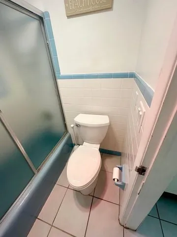 a bathroom with a toilet and a shower