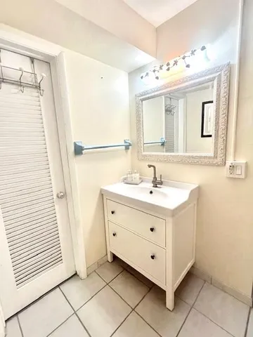 a bathroom with a double vanity sink mirror and