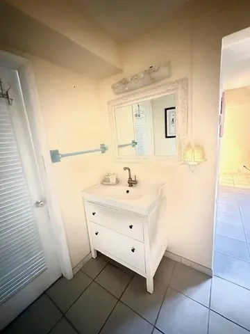 a bathroom with a sink a mirror and a shower