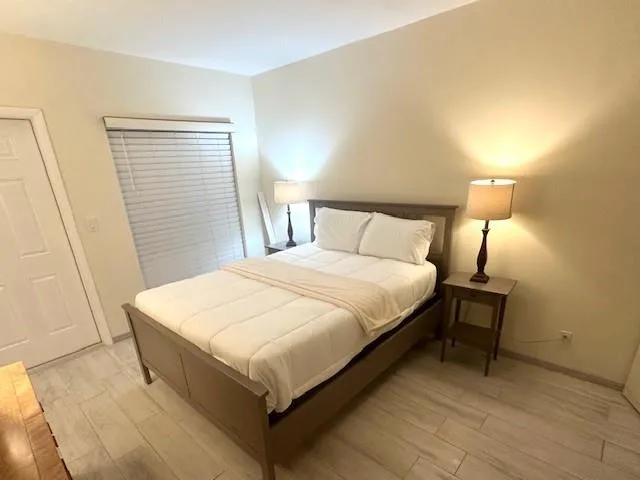 a bedroom with a bed and a night stand