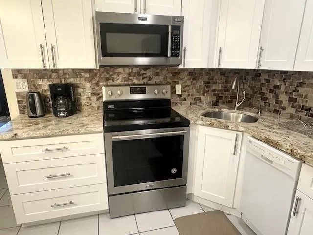 a kitchen with microwave cabinets and stainless steel appliances