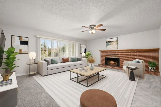 a living room with furniture a fireplace and a table