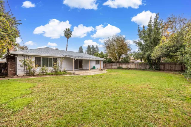 a front view of a house with a garden and yard