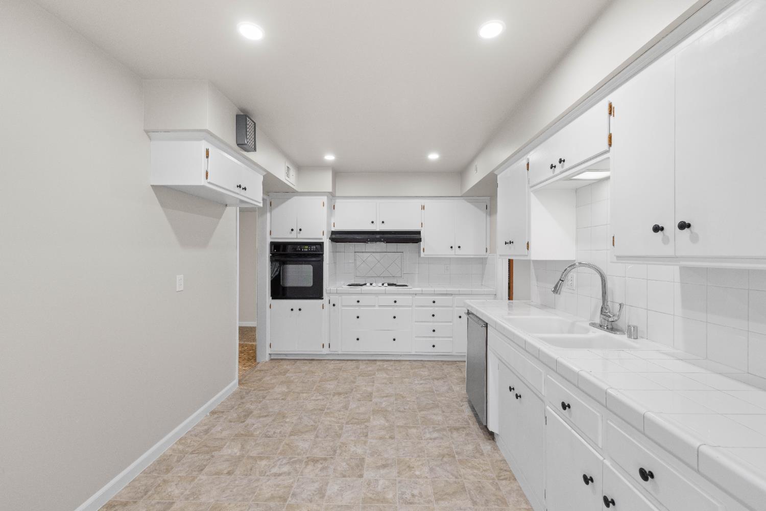 4907 Crestview Drive Carmichael, CA 95608 - Photo 16 of 33 a large white kitchen with cabinets