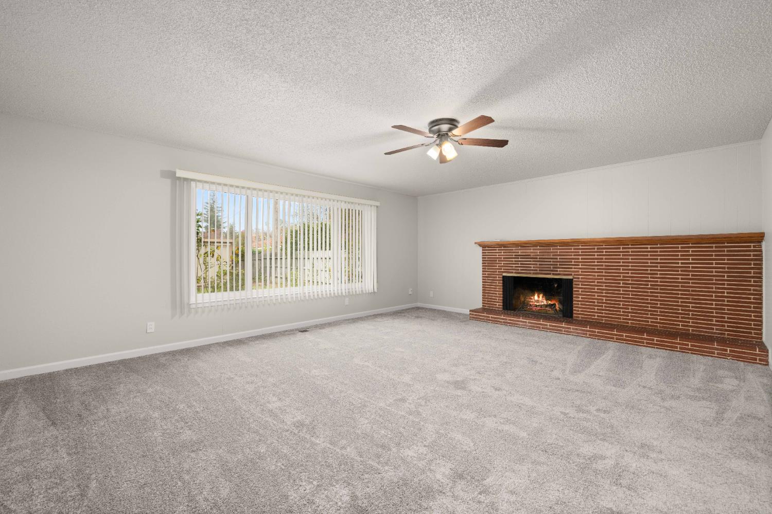 4907 Crestview Drive Carmichael, CA 95608 - Photo 18 of 33 an empty room with fireplace and windows