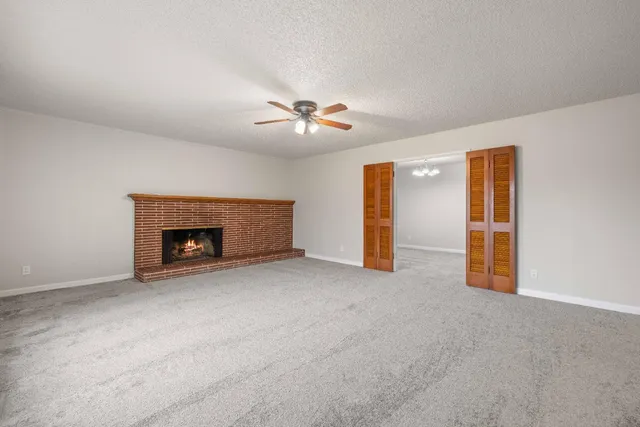a view of an empty room with a fireplace