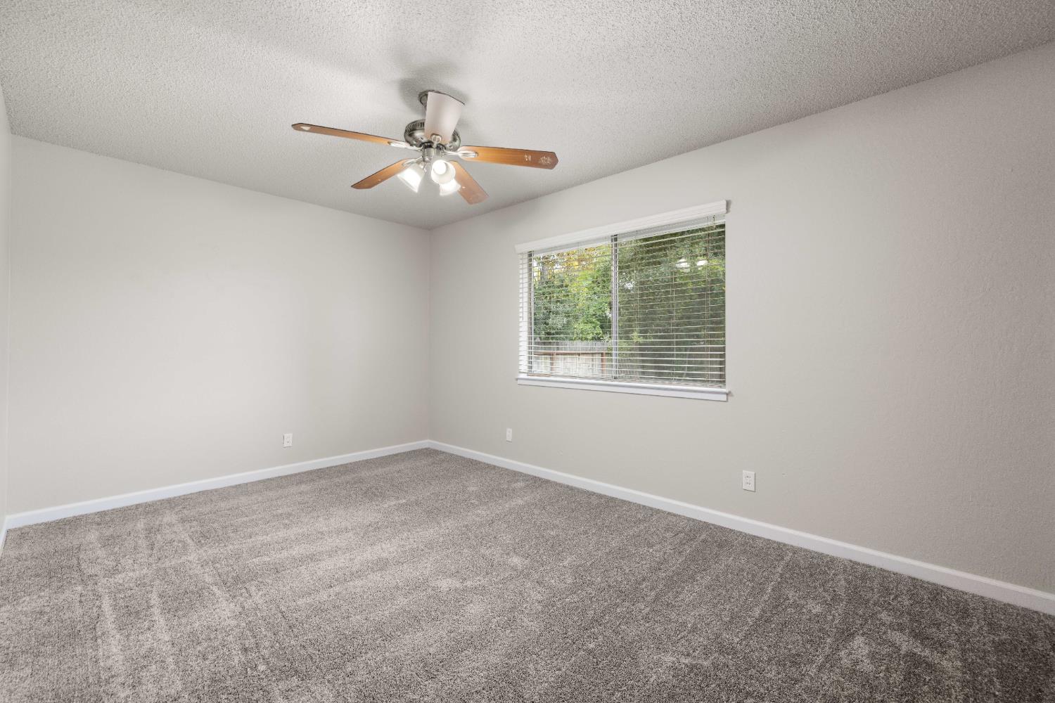 4907 Crestview Drive Carmichael, CA 95608 - Photo 28 of 33 an empty room with a window and a fan