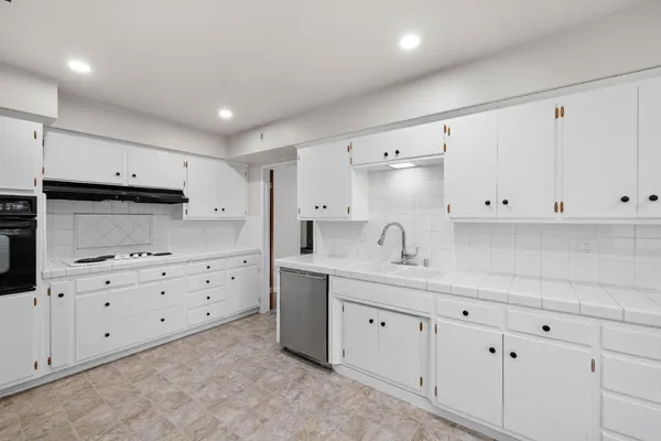 a kitchen that has white cabinets