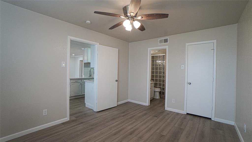 4606 Chaha Road, Unit 103 Garland, TX 75043 - Photo 13 of 23 wooden floor in an empty room with a window