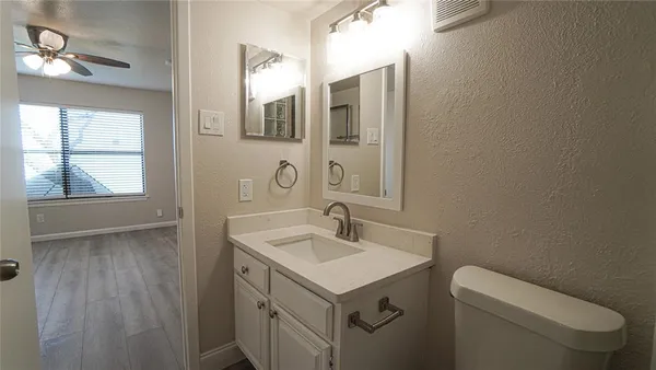 a bathroom with a sink toilet and mirror