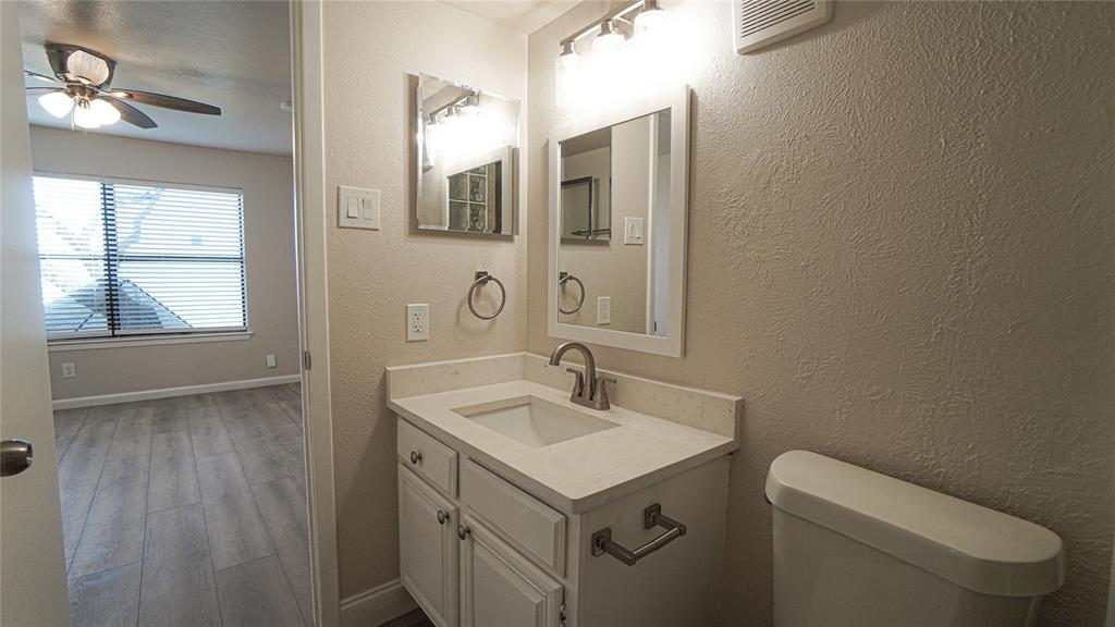 4606 Chaha Road, Unit 103 Garland, TX 75043 - Photo 15 of 23 a bathroom with a sink toilet and mirror