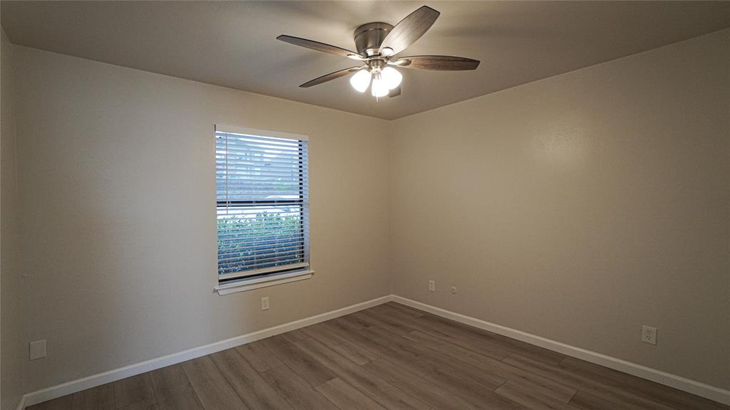 4606 Chaha Road, Unit 103 Garland, TX 75043 - Photo 16 of 23 wooden floor in an empty room with a window