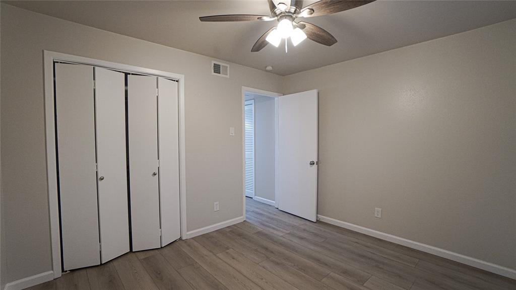 4606 Chaha Road, Unit 103 Garland, TX 75043 - Photo 17 of 23 a view of an empty room with wooden floor