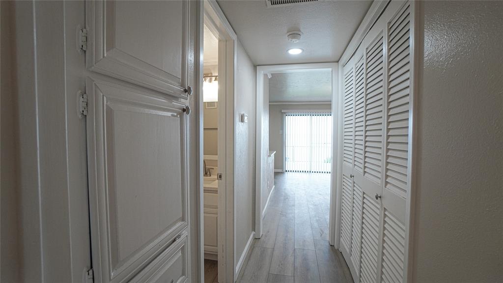 4606 Chaha Road, Unit 103 Garland, TX 75043 - Photo 18 of 23 a view of a hallway with wooden floor and closet area