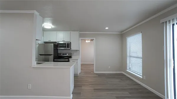 a kitchen with stainless steel appliances a refrigerator and a stove top oven