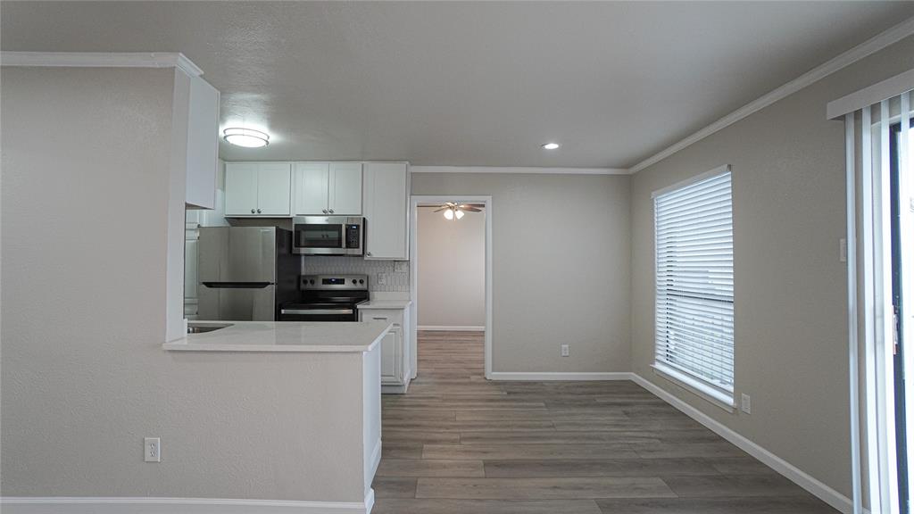 4606 Chaha Road, Unit 103 Garland, TX 75043 - Photo 7 of 23 a kitchen with stainless steel appliances a refrigerator and a stove top oven