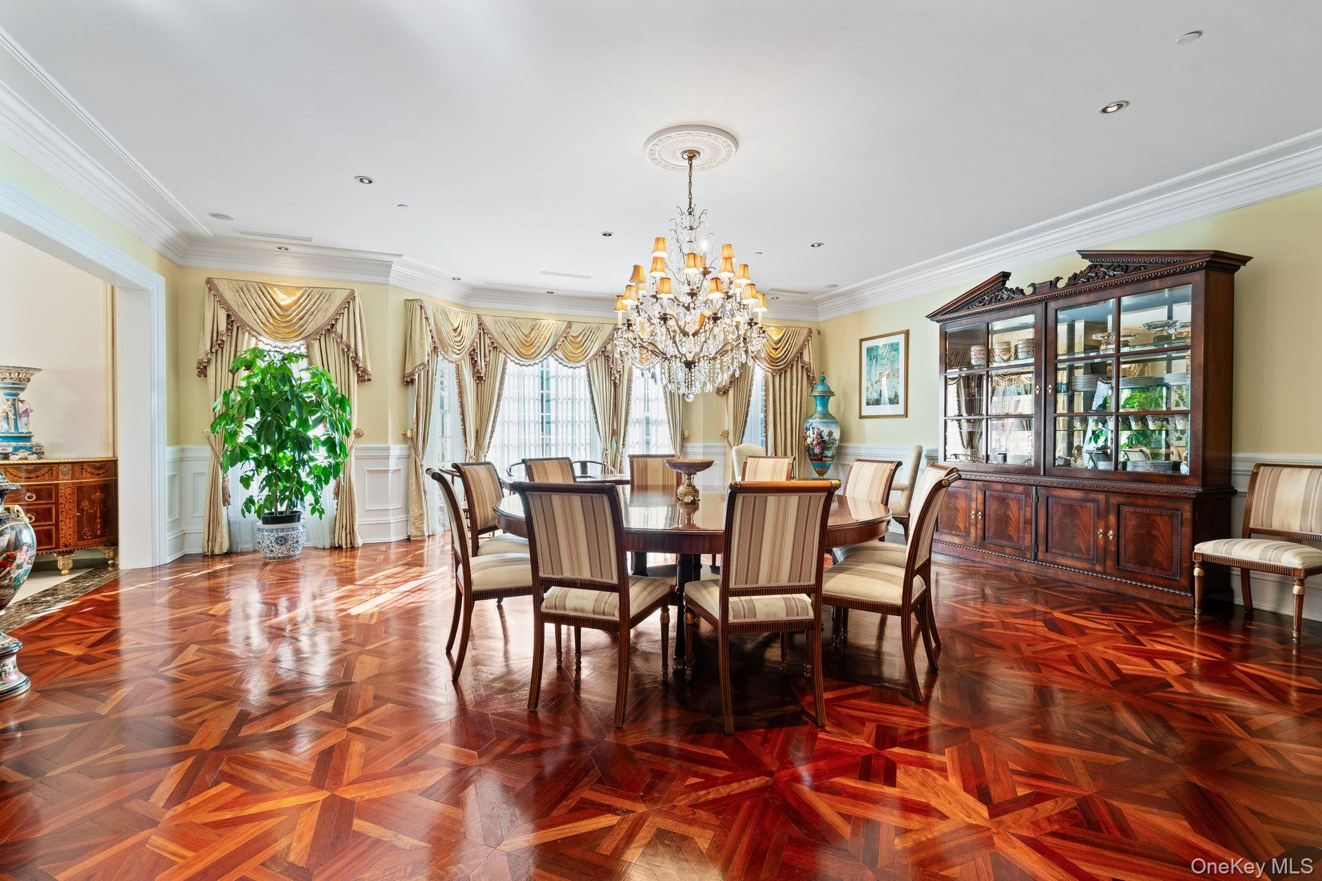 660 Chicken Valley Road Locust Valley, NY 11560 - Photo 12 of 48 Spacious room featuring intricate parquet wood flooring, a crystal chandelier, recessed lighting, crown molding, and wainscoting