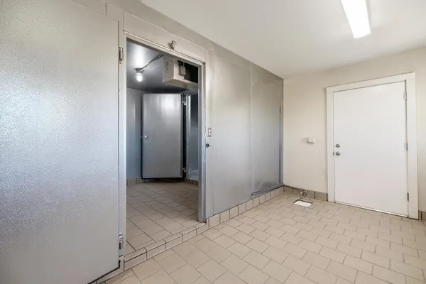 a view of a hallway with wooden shelves