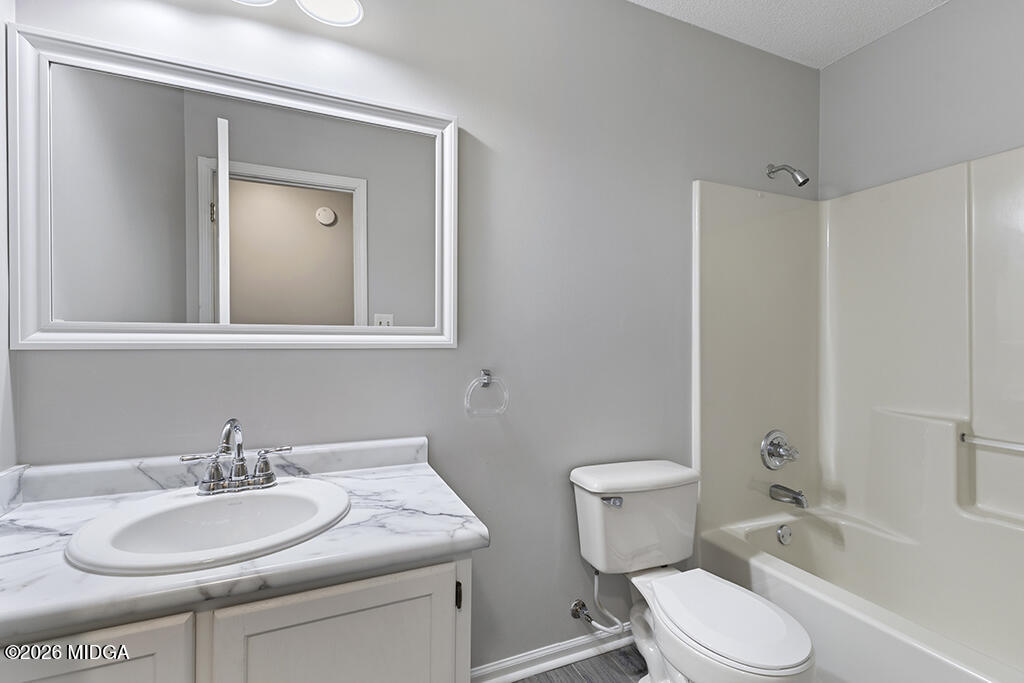 103 Echeconnee Ridge Road Warner Robins, GA 31093 - Photo 16 of 25 a bathroom with a sink toilet vanity and shower