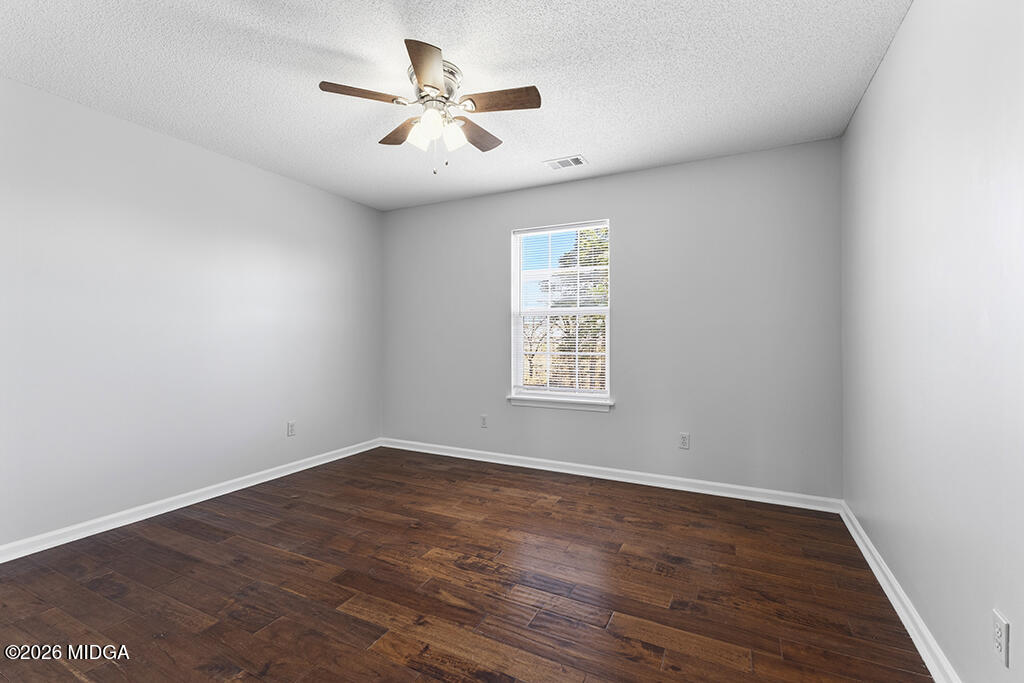 103 Echeconnee Ridge Road Warner Robins, GA 31093 - Photo 17 of 25 an empty room with wooden floor and windows