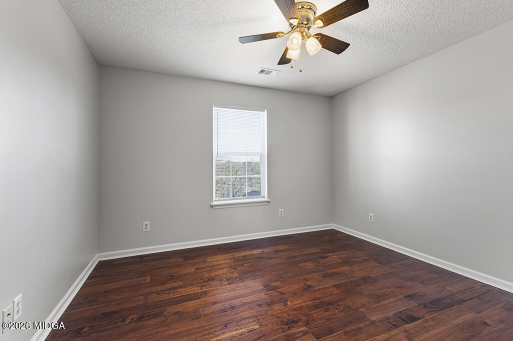 103 Echeconnee Ridge Road Warner Robins, GA 31093 - Photo 19 of 25 wooden floor in an empty room with a window
