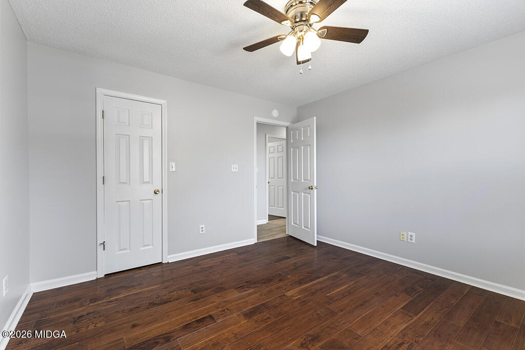 103 Echeconnee Ridge Road Warner Robins, GA 31093 - Photo 20 of 25 a view of an empty room with wooden floor