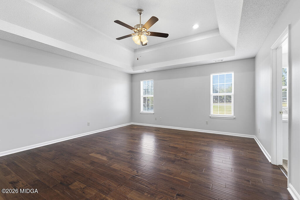 103 Echeconnee Ridge Road Warner Robins, GA 31093 - Photo 21 of 25 an empty room with wooden floor and windows