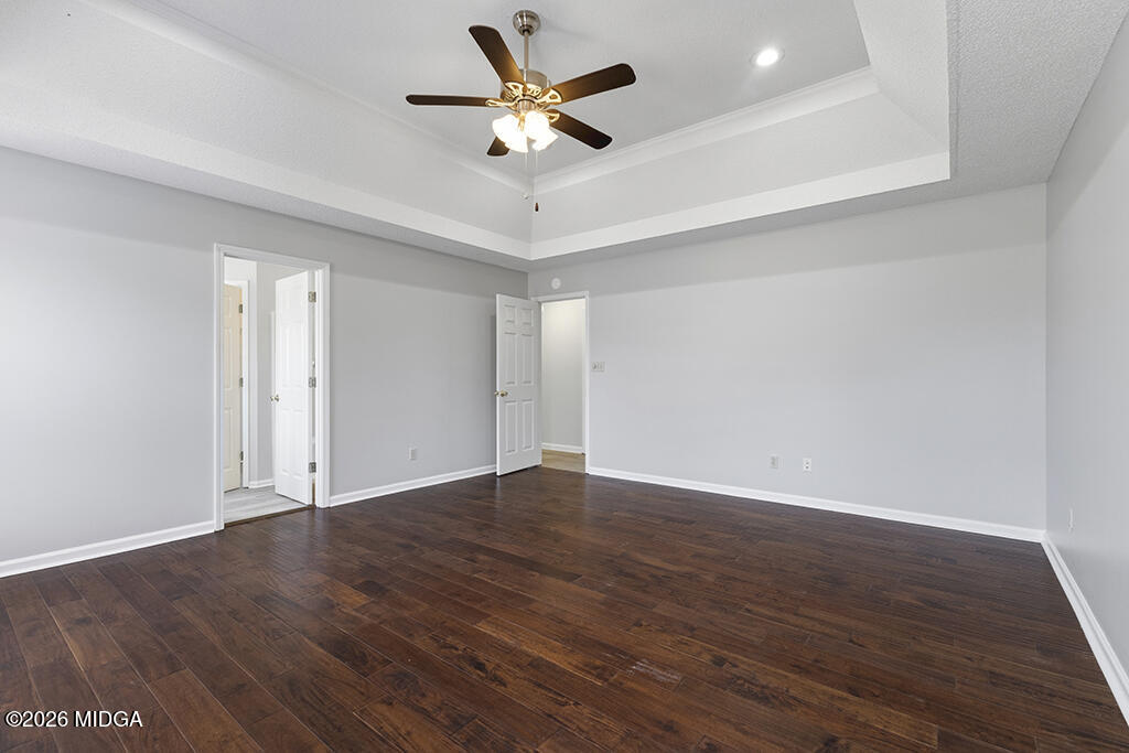 103 Echeconnee Ridge Road Warner Robins, GA 31093 - Photo 22 of 25 an empty room with wooden floor and a ceiling fan