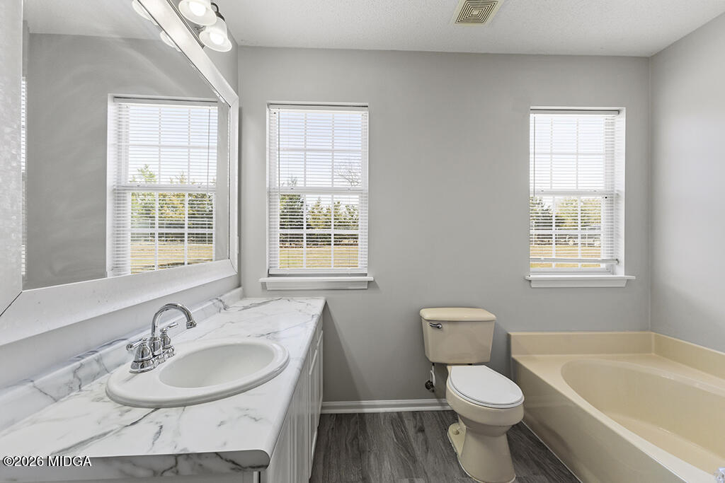 103 Echeconnee Ridge Road Warner Robins, GA 31093 - Photo 23 of 25 a bathroom with a sink toilet a tub and shower