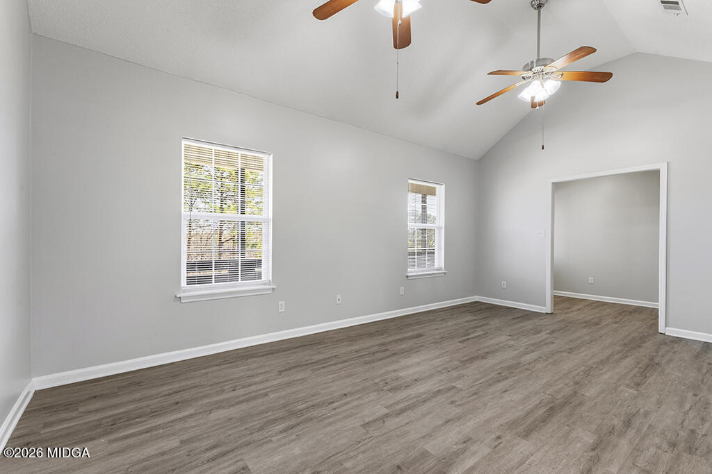103 Echeconnee Ridge Road Warner Robins, GA 31093 - Photo 10 of 25 an empty room with wooden floor fan and windows