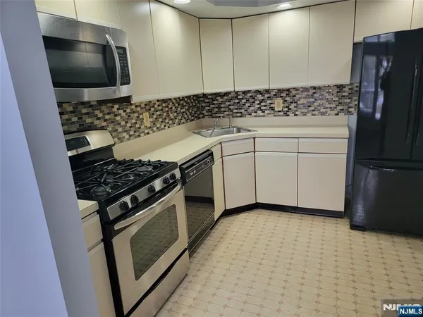 a kitchen with a stove and a refrigerator