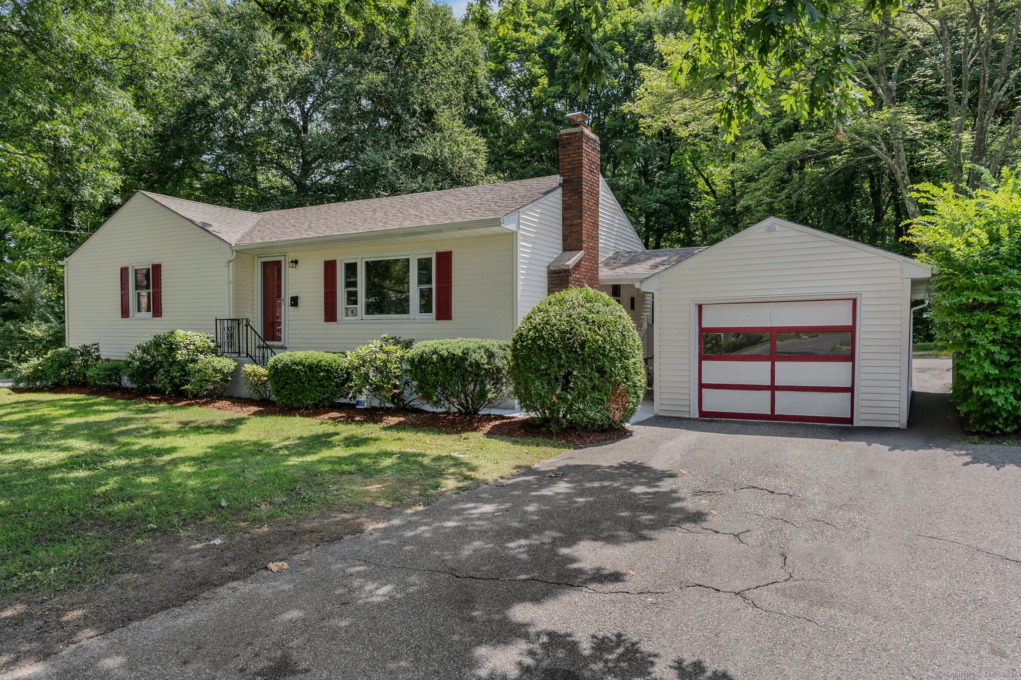 303 Bunker Hill Avenue Waterbury, CT 06708 - Photo 1 of 1 front view of a house with a yard and potted plants