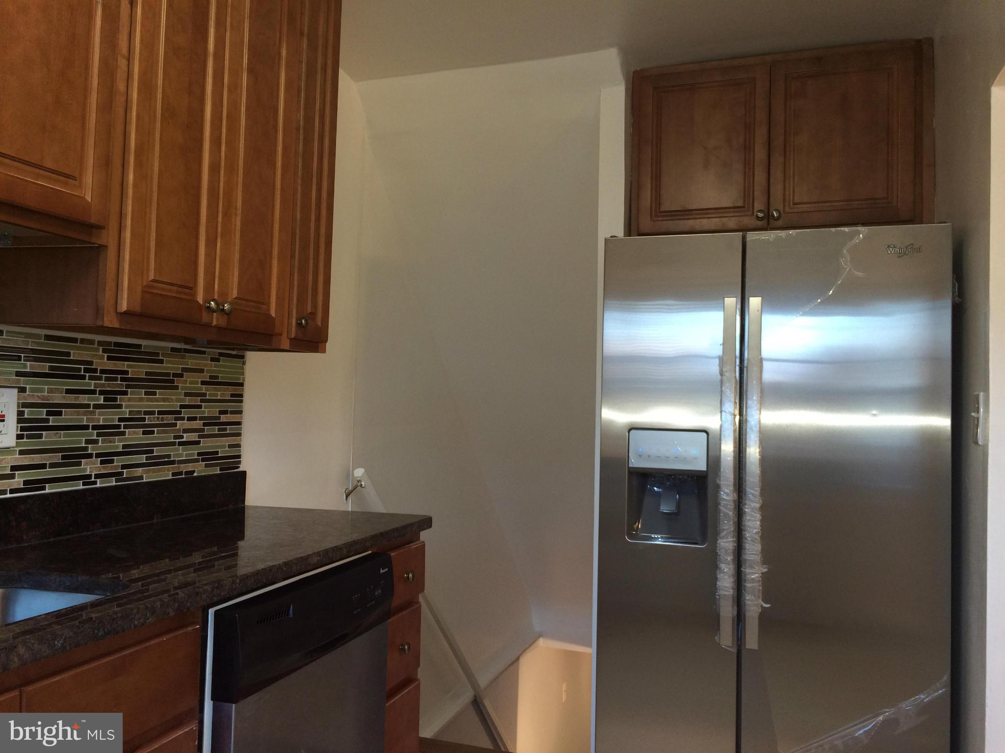 4415 Fenor Road Halethorpe, MD 21227 - Photo 15 of 29 a kitchen with a refrigerator and cabinets
