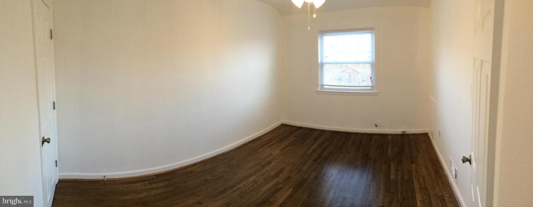 4415 Fenor Road Halethorpe, MD 21227 - Photo 16 of 29 an empty room with wooden floor and windows