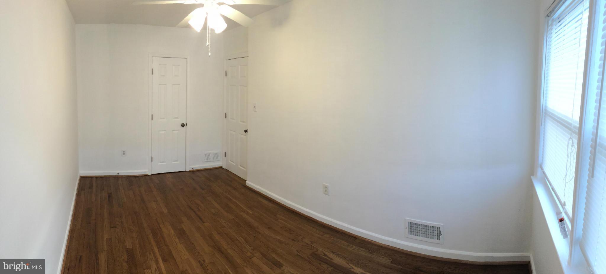 4415 Fenor Road Halethorpe, MD 21227 - Photo 19 of 29 an empty room with wooden floor and windows