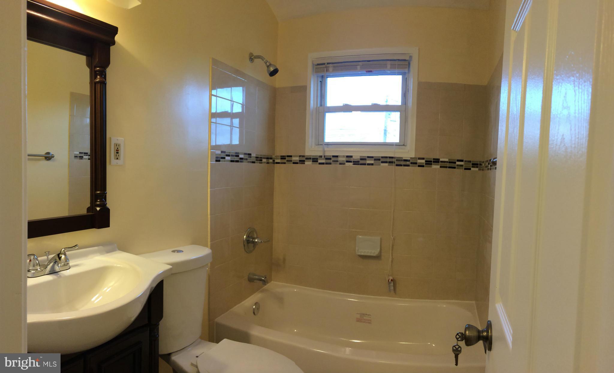 4415 Fenor Road Halethorpe, MD 21227 - Photo 21 of 29 a bathroom with a tub sink and mirror