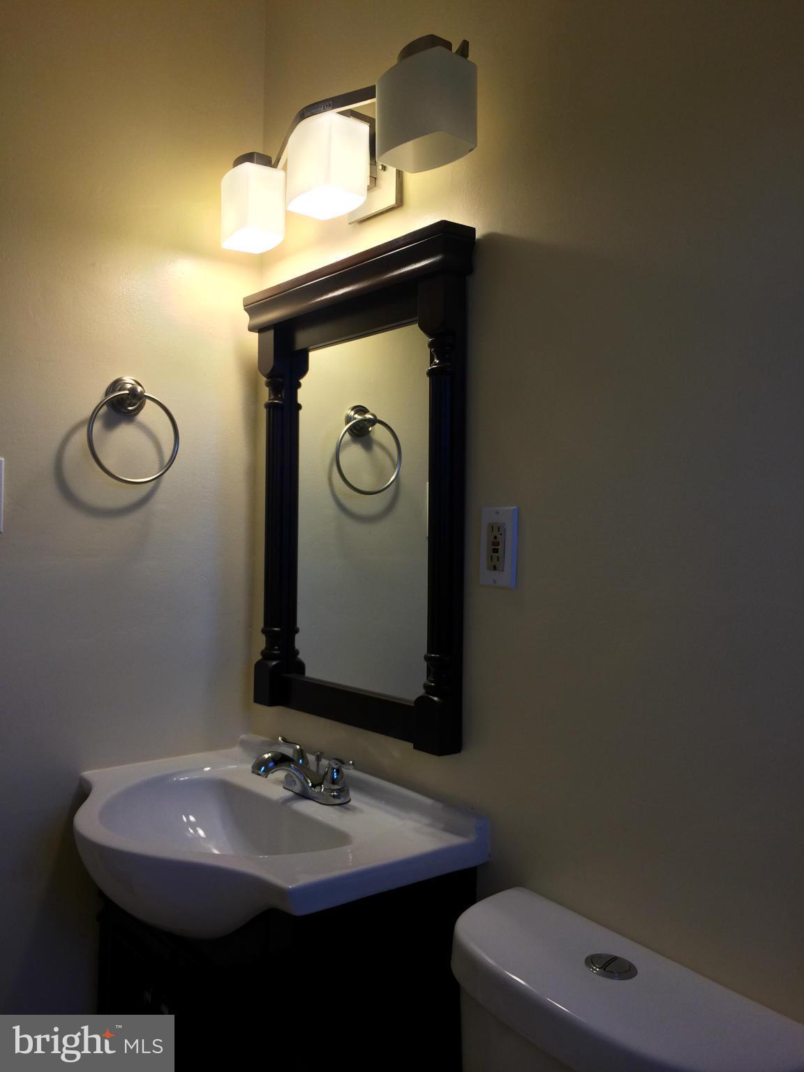4415 Fenor Road Halethorpe, MD 21227 - Photo 23 of 29 a bathroom with a sink and a mirror