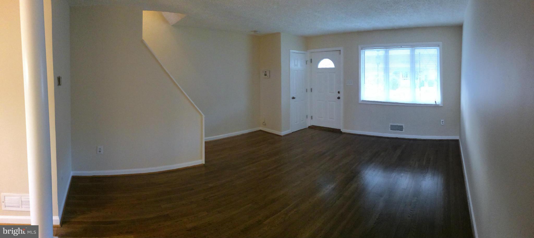 4415 Fenor Road Halethorpe, MD 21227 - Photo 8 of 29 a view of an empty room with wooden floor and a window