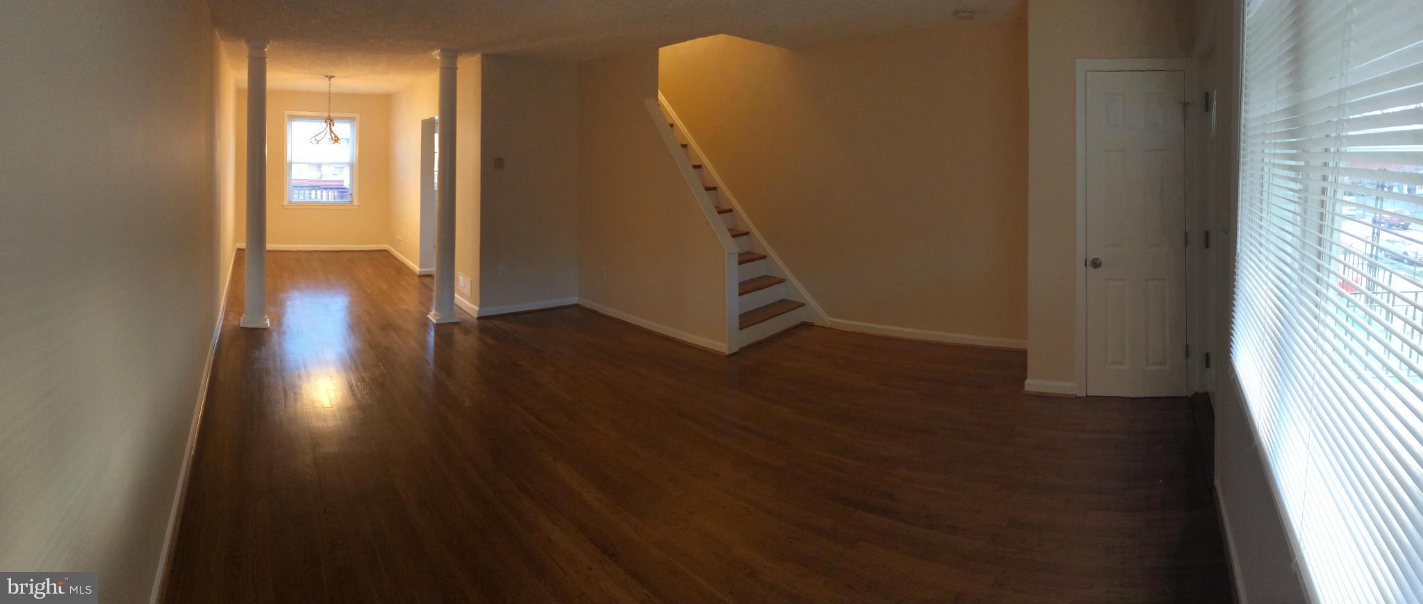 4415 Fenor Road Halethorpe, MD 21227 - Photo 9 of 29 a view of a hallway with wooden floor and a bathroom