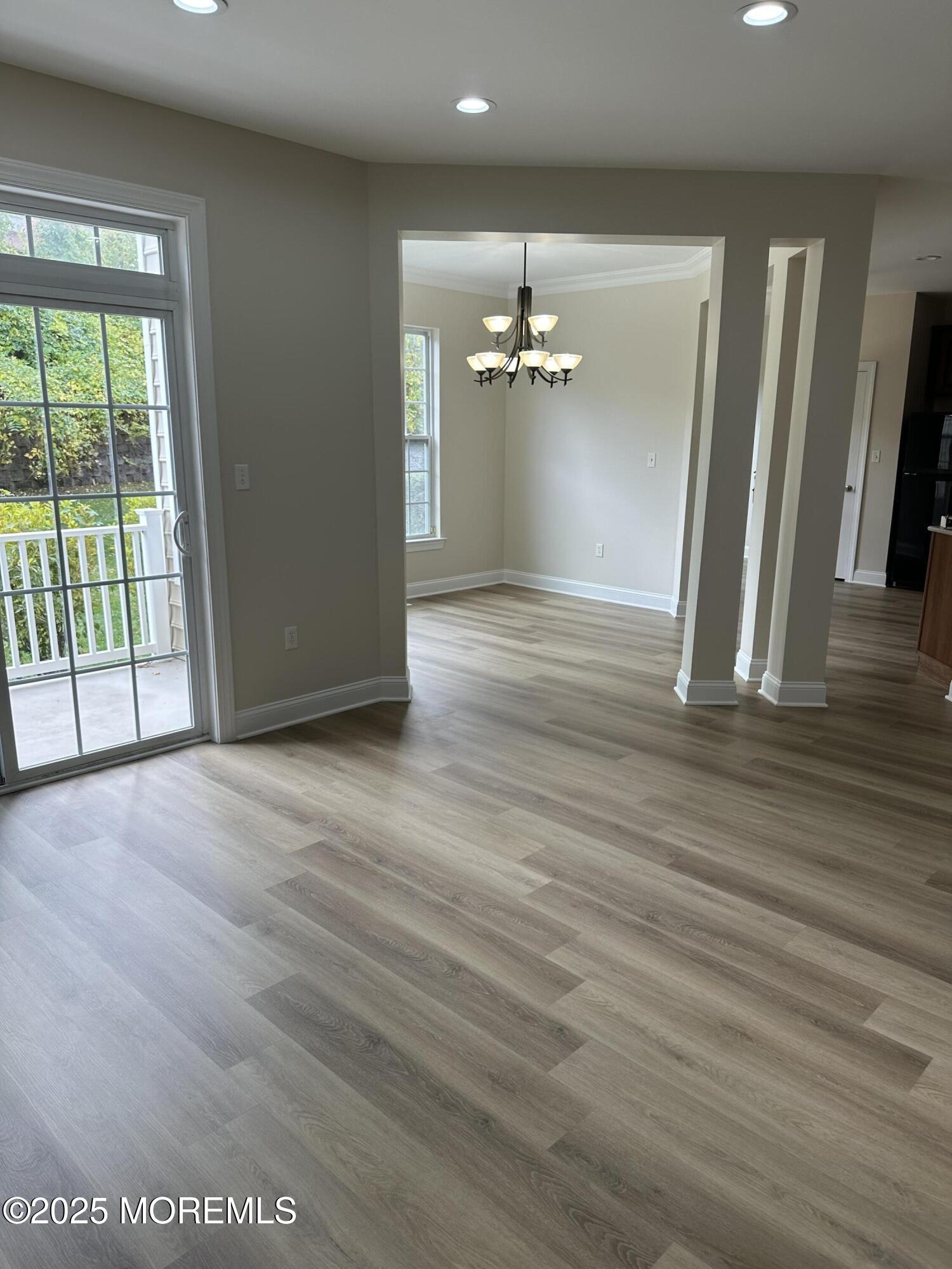 1006 Abby Road Middletown, NJ 07748 - Photo 11 of 36 an empty room with wooden floor and windows