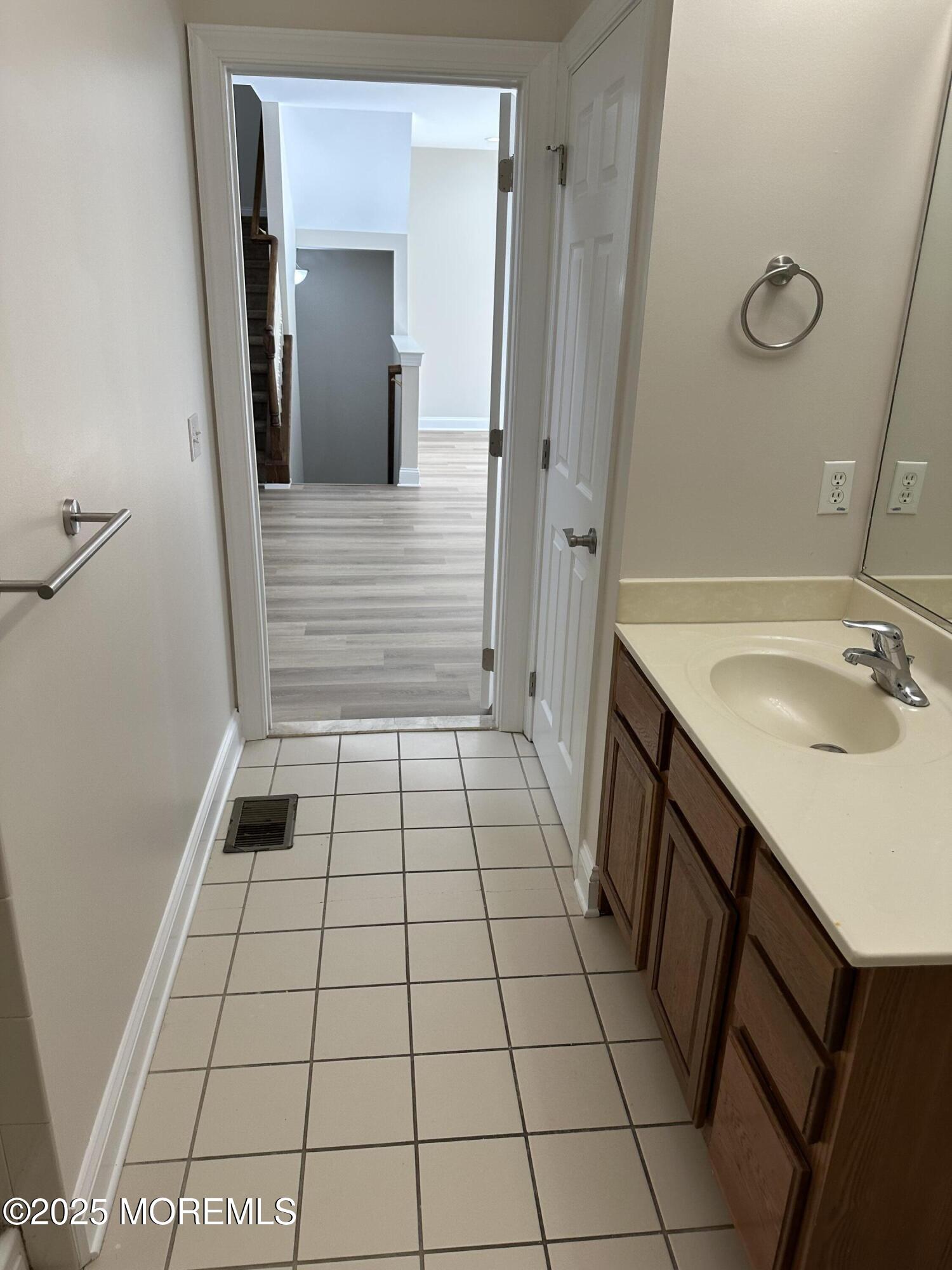1006 Abby Road Middletown, NJ 07748 - Photo 17 of 36 a bathroom with a sink and a mirror