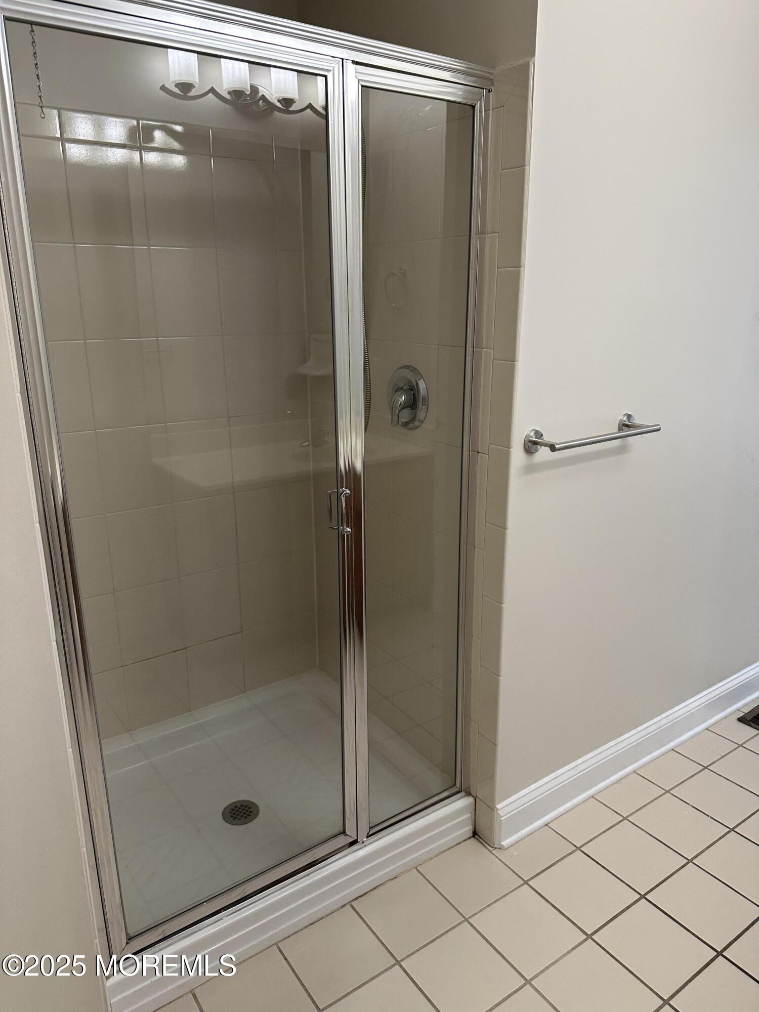 1006 Abby Road Middletown, NJ 07748 - Photo 18 of 36 a bathroom with a glass shower door