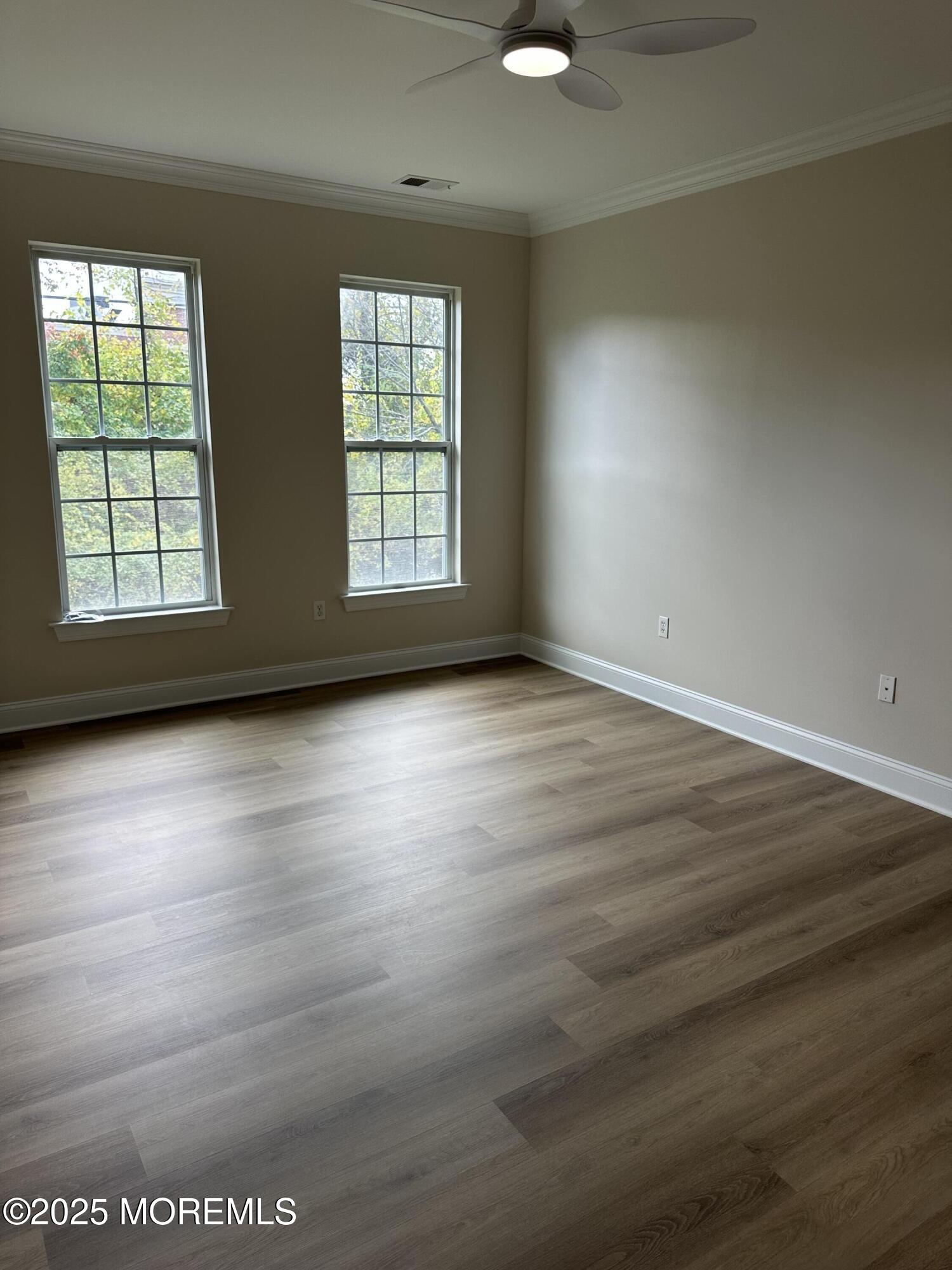 1006 Abby Road Middletown, NJ 07748 - Photo 20 of 36 an empty room with wooden floor and windows