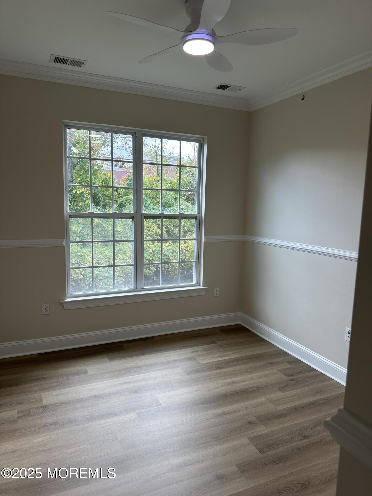 1006 Abby Road Middletown, NJ 07748 - Photo 25 of 36 an empty room with wooden floor and windows