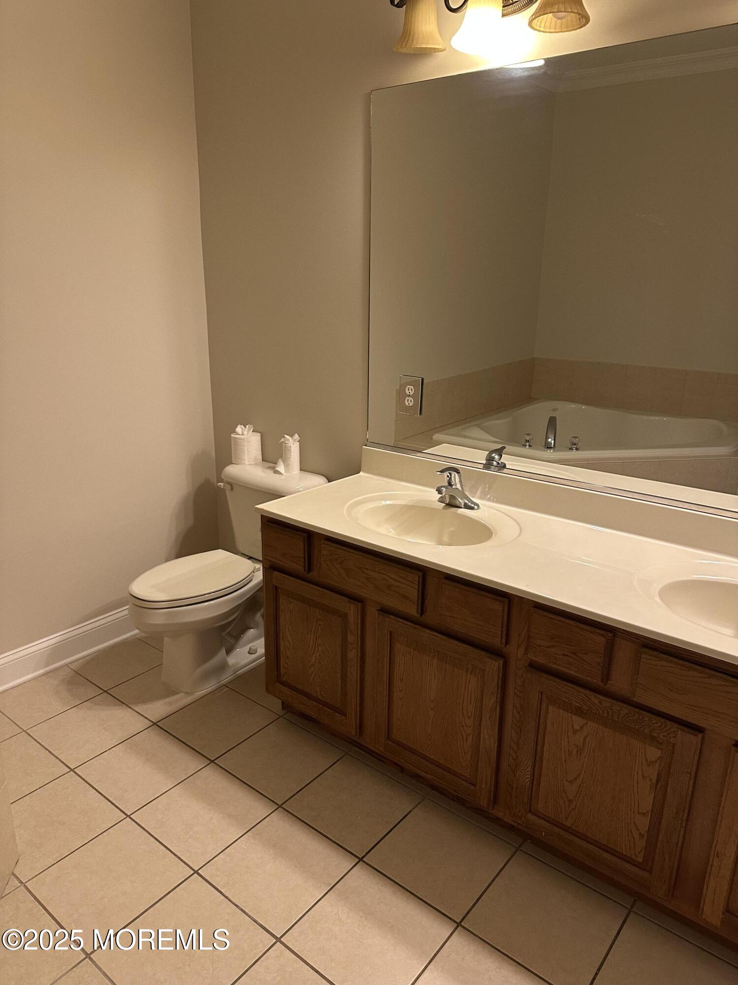 1006 Abby Road Middletown, NJ 07748 - Photo 27 of 36 a bathroom with a sink and a toilet