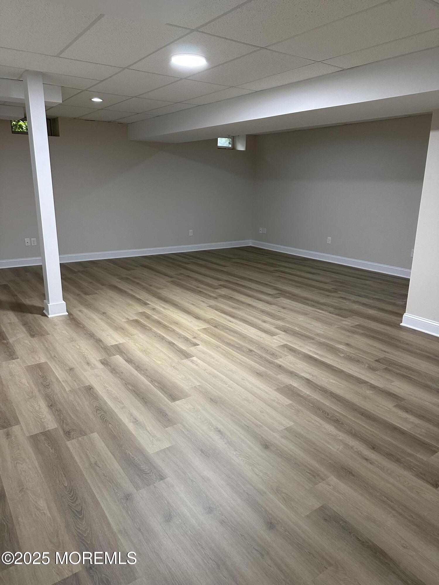 1006 Abby Road Middletown, NJ 07748 - Photo 31 of 36 an empty room with wooden floor and entrance